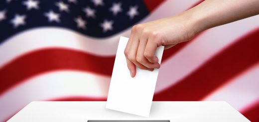 hand with ballot and box on flag of usa