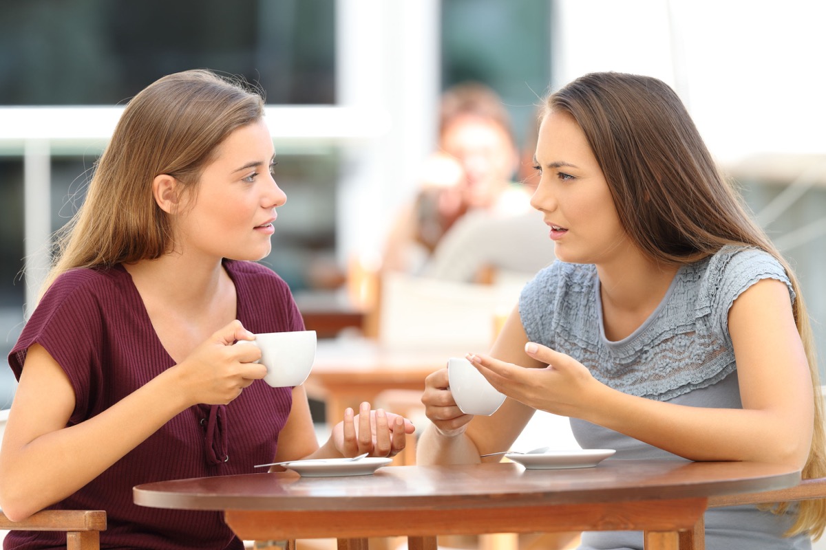 Two serious friends talking sitting in a restaurant; Unionizing First Steps concept