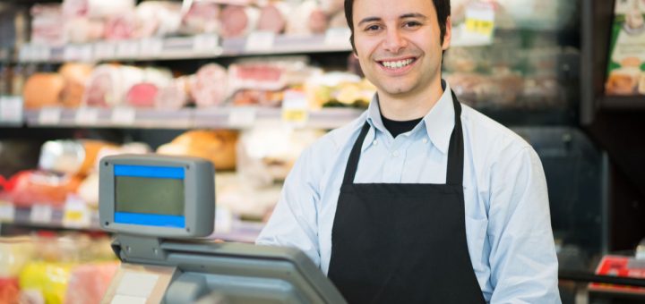 Portrait of a smiling shopkeeper in a grocery store