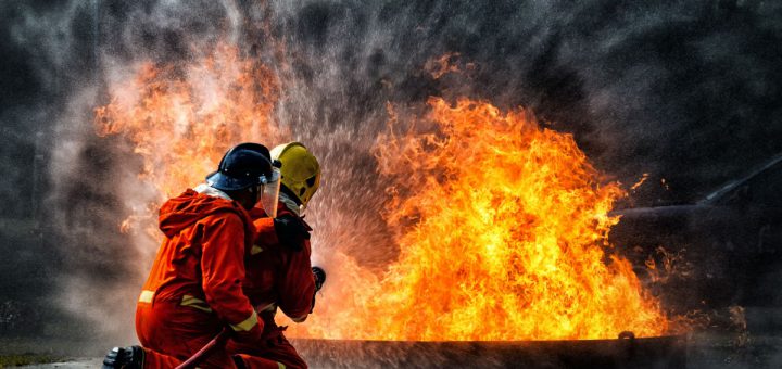 firefighter training., fireman using water and extinguisher to fighting with fire flame in an emergency situation., under danger situation all firemen wearing fire fighter suit for safety.