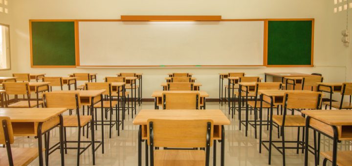 Lecture room or School empty classroom with desks and chair iron wood for studying lessons in high school thailand, interior of secondary education, with whiteboard, vintage tone educational concept