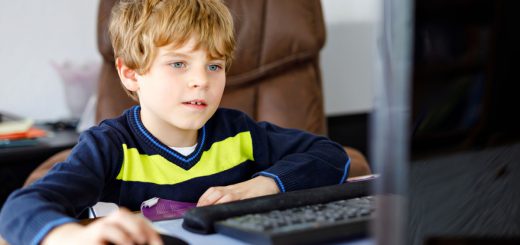 Little kid boy making school homework on computer notebook. Happy healthy child searching information on internet. New media education, kid watching learning lessons on pc. Virtual classroom