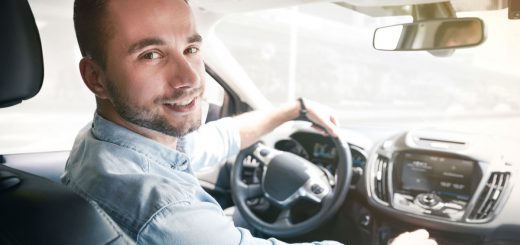 Young male driver behind the wheel. Sharing economy service or taxi driver concept