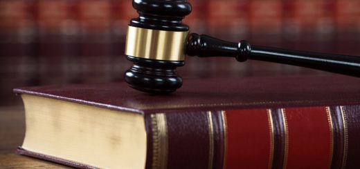 Closeup of mallet on legal book at table in courtroom