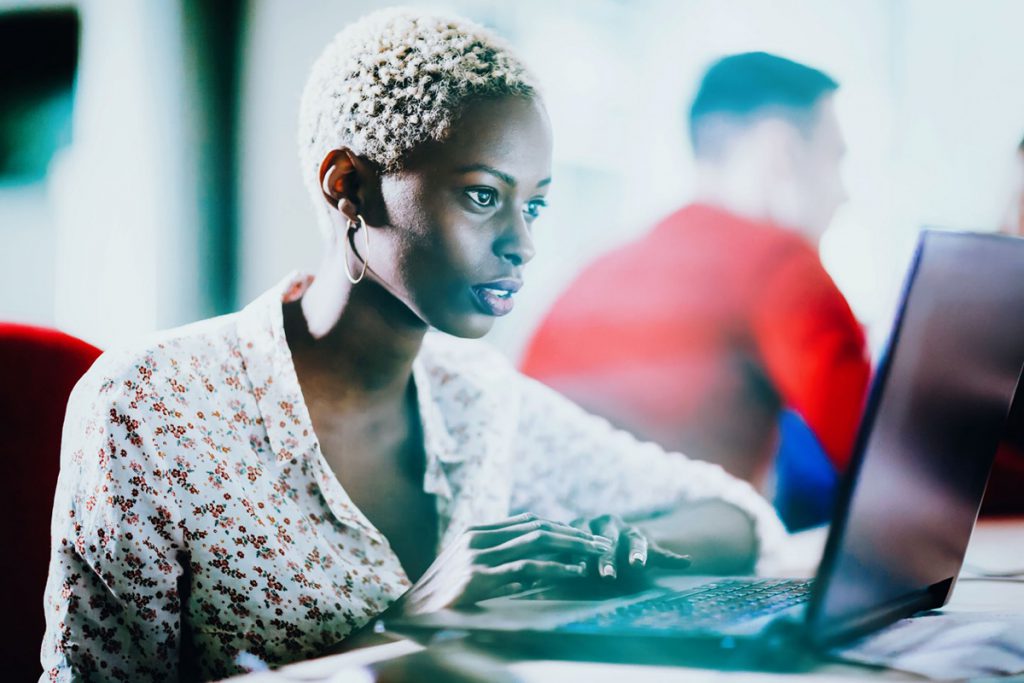 Female programmer working on IT project at company office