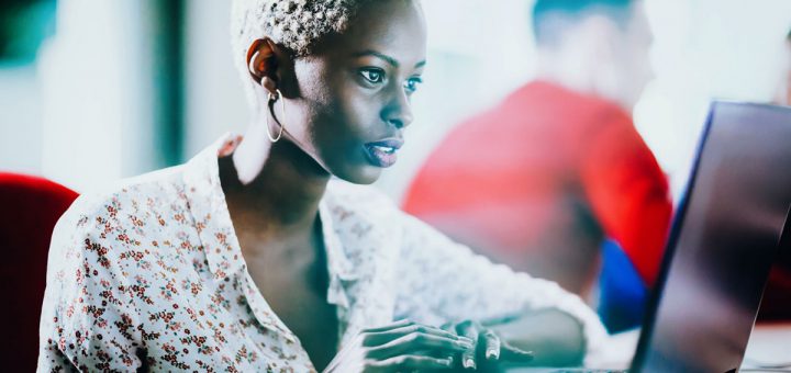 Female programmer working on IT project at company office