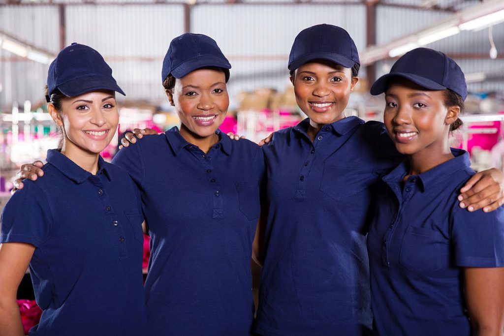 portrait of beautiful young textile factory co-workers