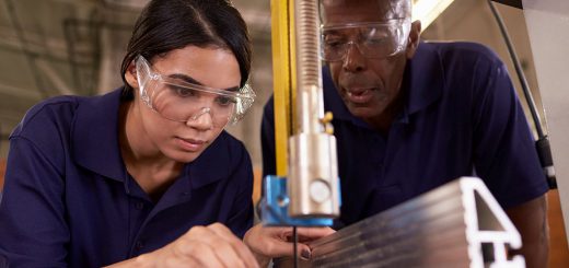 Carpenter Training Female Apprentice To Use Mechanized Saw