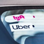 Dec 19, 2019 Redwood City / CA / USA - Lyft and UBER stickers on the rear window of a vehicle offering rides in San Francisco Bay Area