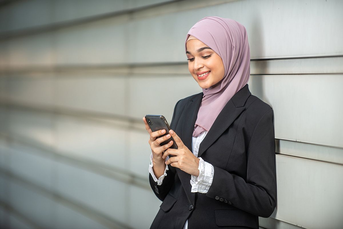 Young female worker looking at her smartphone; forming a union organizing committee concept