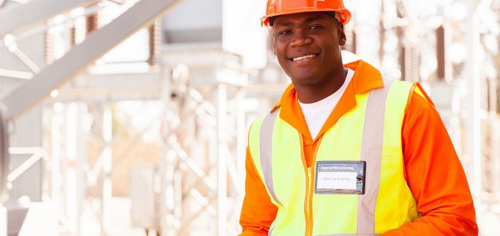 handsome male african electrical engineer in substation