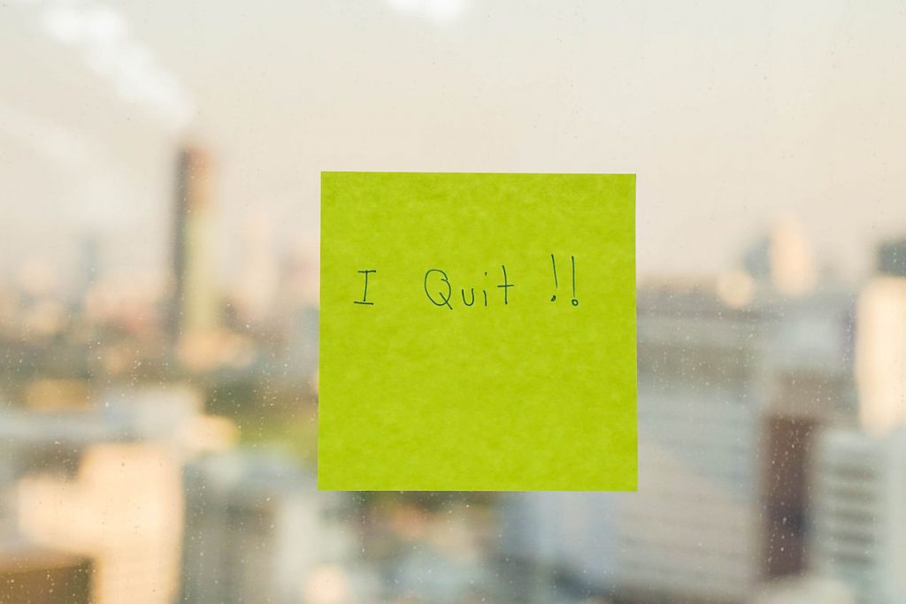 Postit with "I Quit" message on office window; Great Resignation labor unions concept