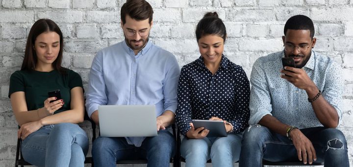 young people sit on chairs indoor with different mobile devices; unions connect with digital natives concept