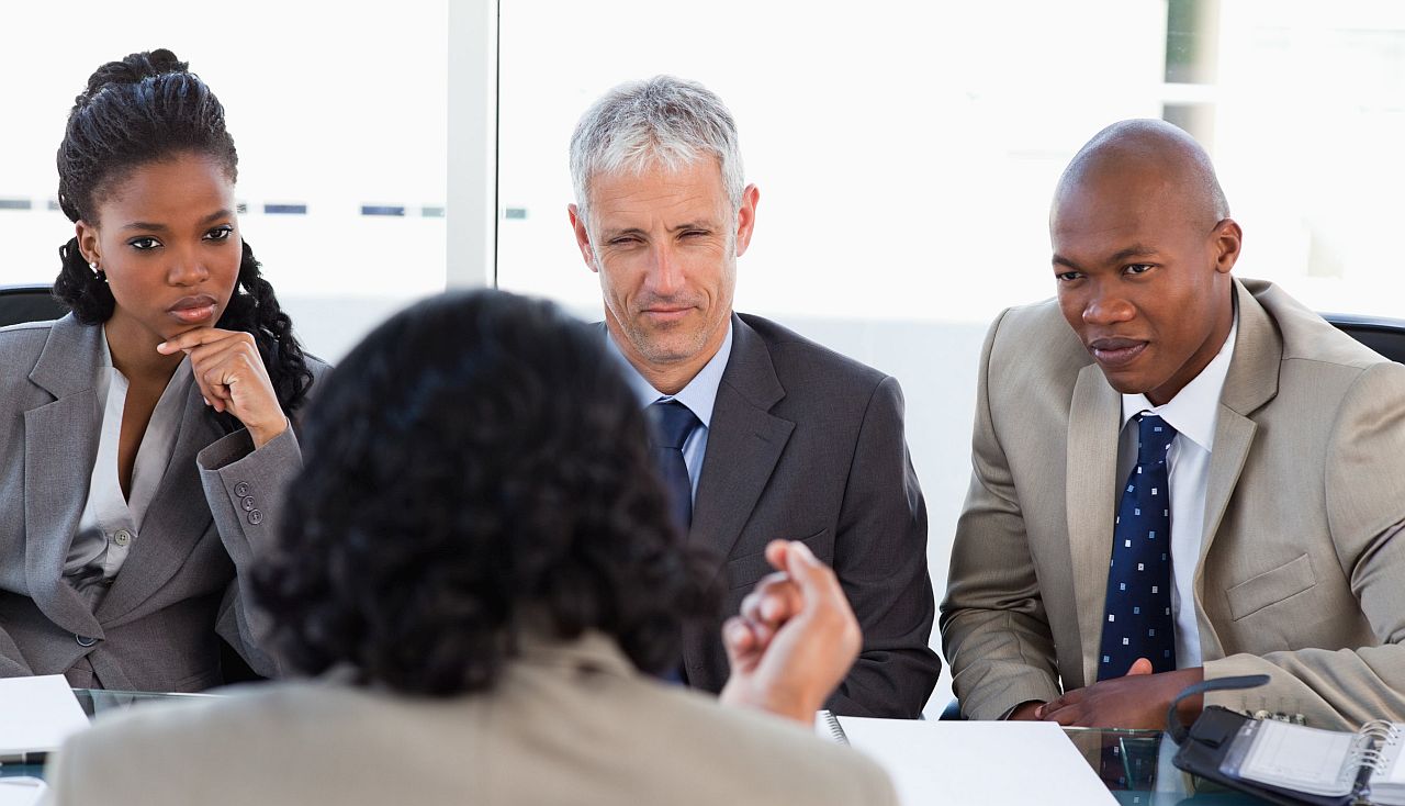 Three executives listening to a worker; workers unions gains concept