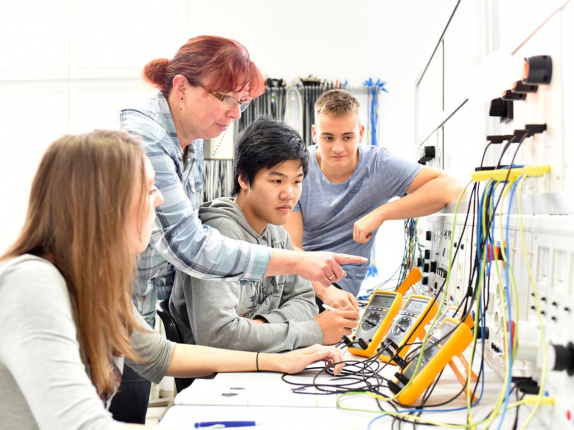 Group of young people in technical vocational training with teacher; Next Generation of Workers concept
