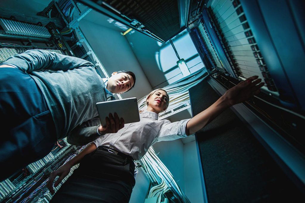 Young engineers in network server room; union drives spring 2022 concept