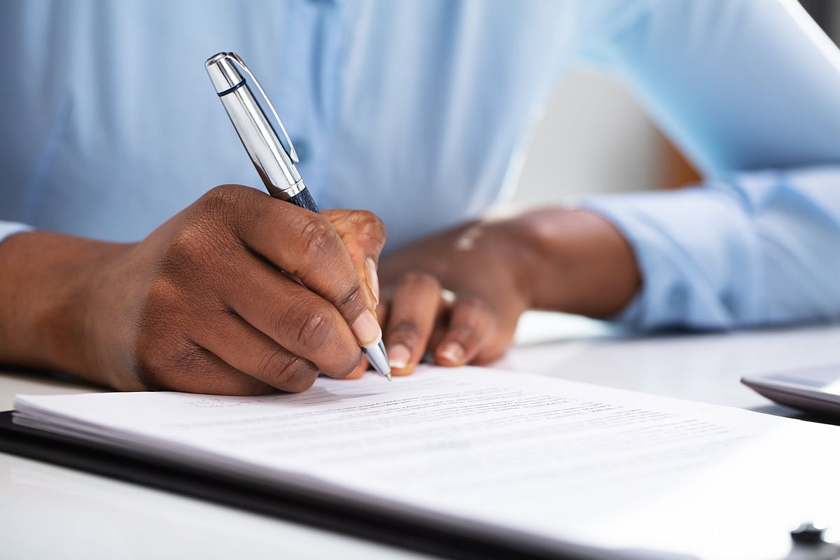 Close-up Of A Hand Filling Contract Form; Jennifer Abruzzo initiatives at the NLRB concept