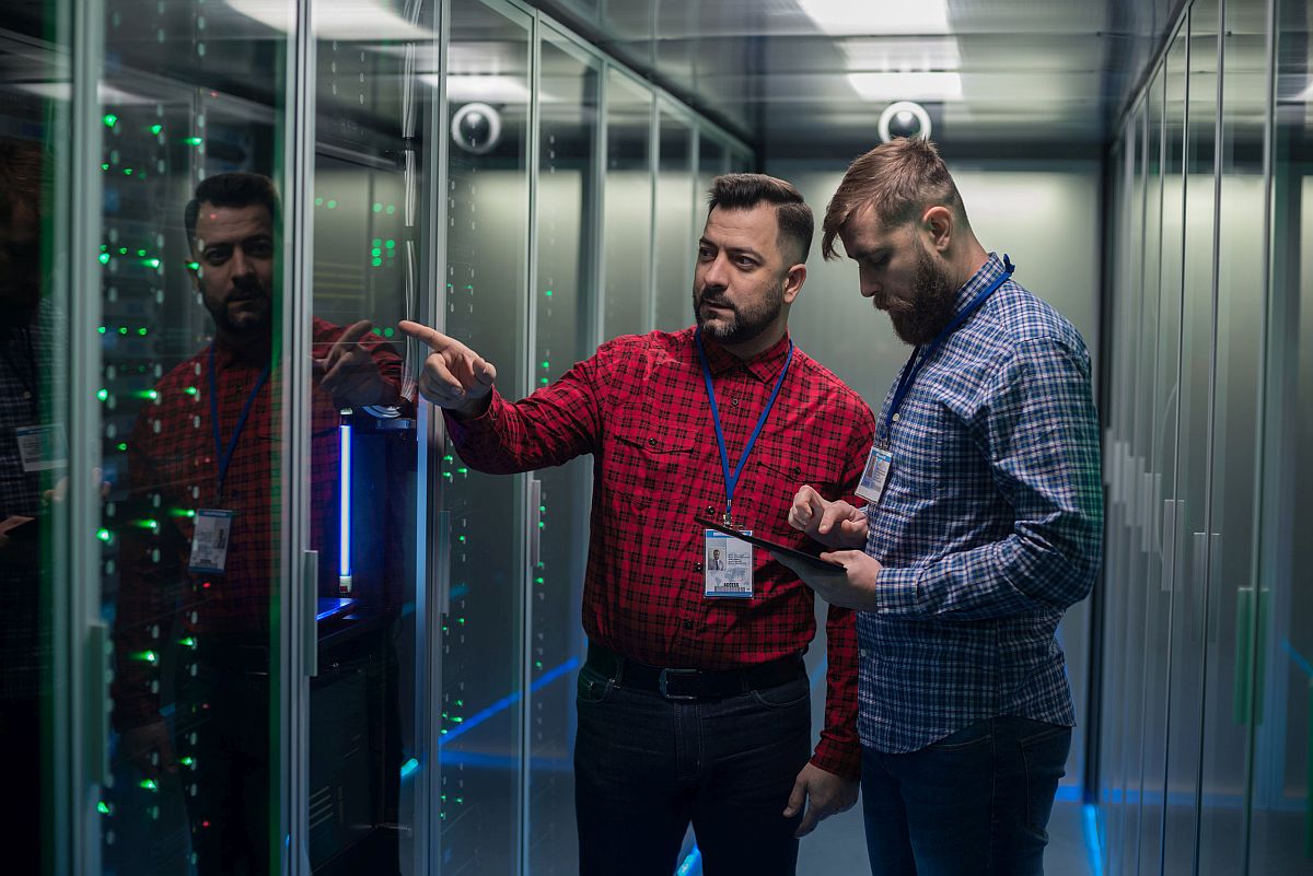 Portrait of two adult bearded man standing in corridor of server room; union drives spring 2022 concept