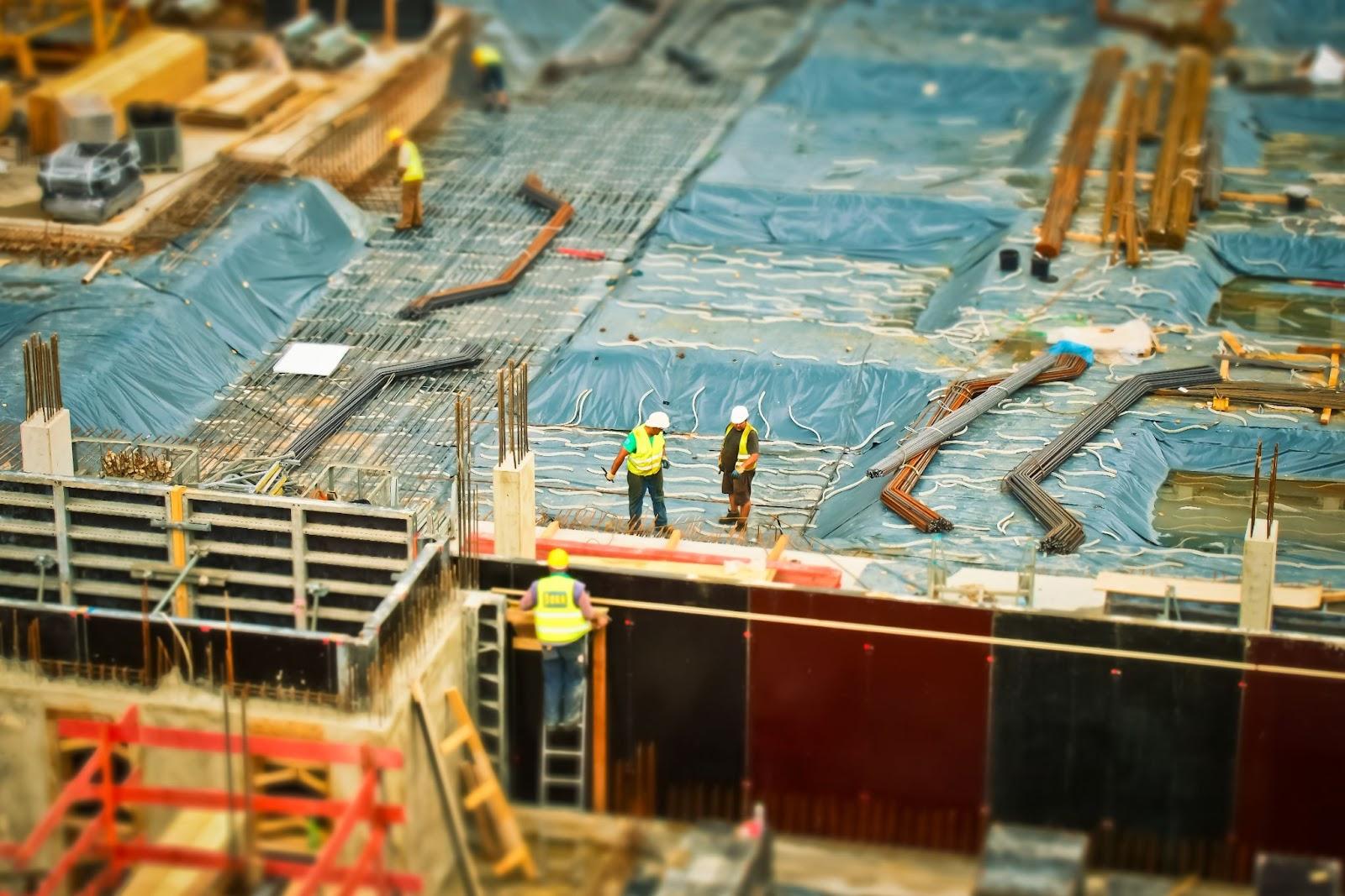 Workers at a constructions site; federal leaders and unions concept