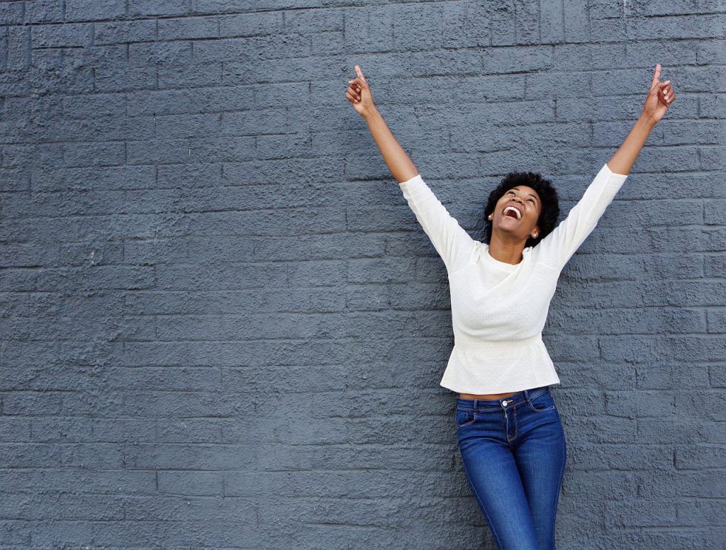 Happy woman raising her arms in victory; successful union election concept