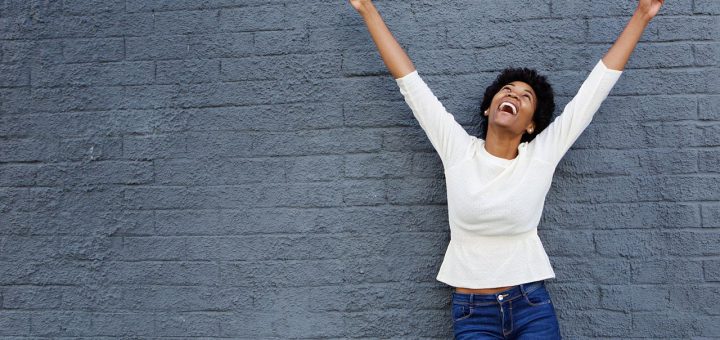 Happy woman raising her arms in victory; successful union election concept