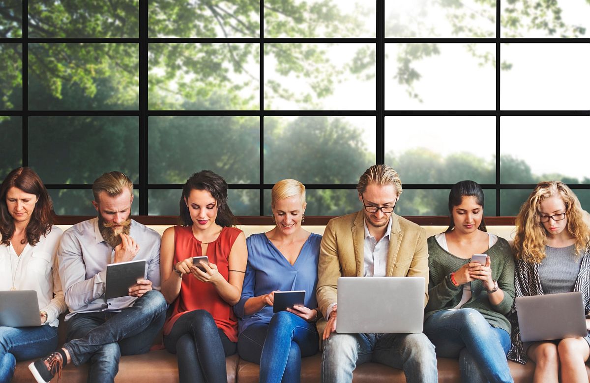 Group of professionals using phones, tables and laptops; strong union membership concept