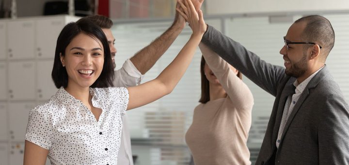 Happy group of people giving high-fives; NLRB certification concept