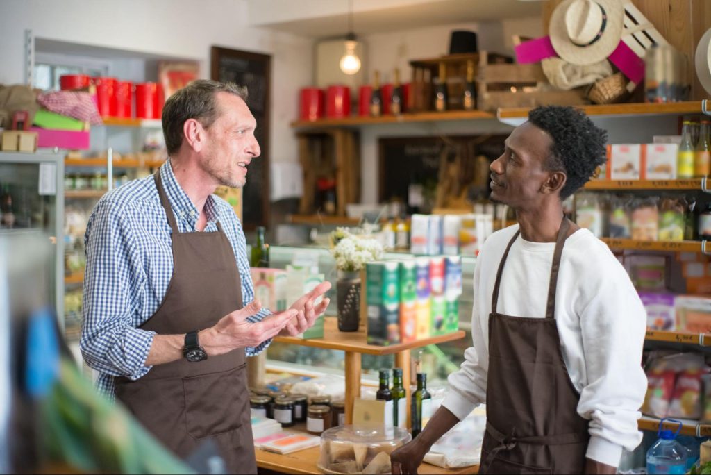 two grocery workers talking; collective bargaining concept