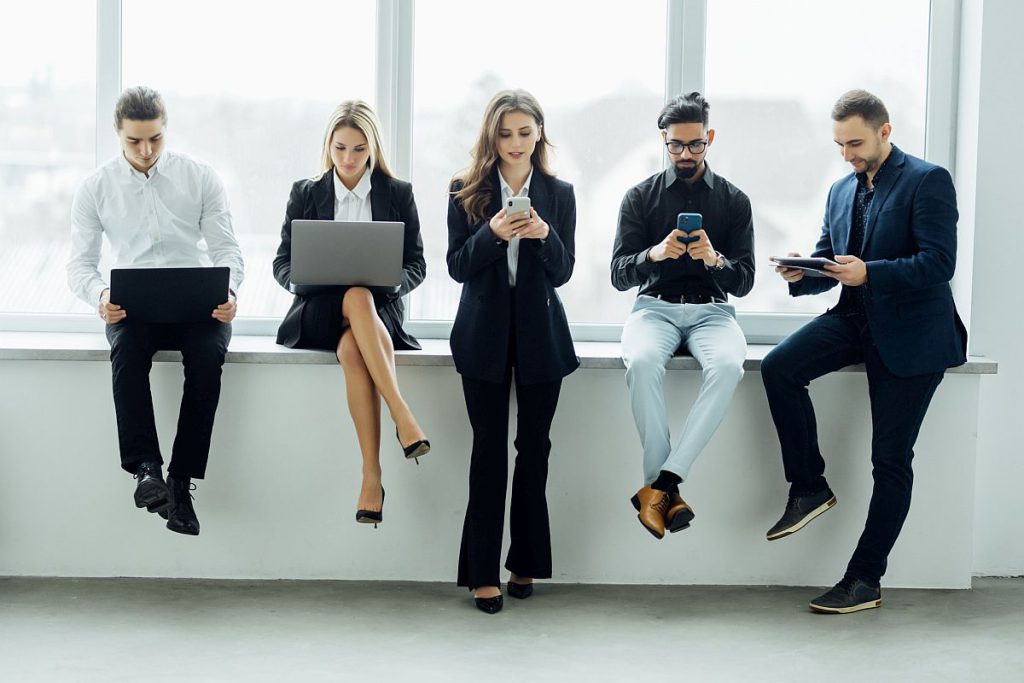 workers on laptops and smart phones; collective bargaining concept