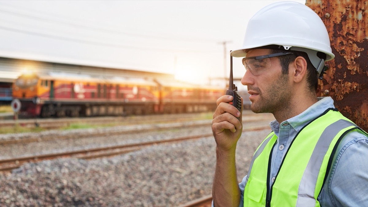 Railway worker in rail yard on two-way radio; paid sick leave concept