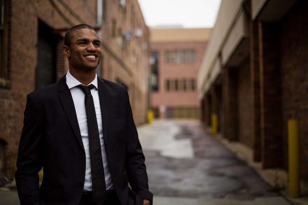 Smiling man in suit; worker wins fall 2022 concept