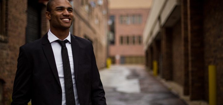 Smiling man in suit; worker wins fall 2022 concept