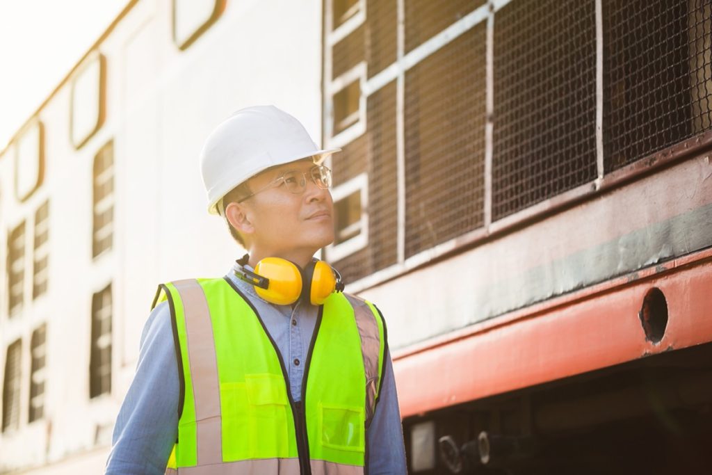 Railway safety inspector looking at train; derailment concept