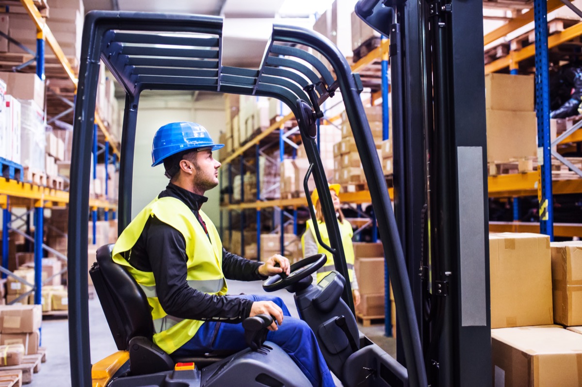 Young warehouse workers working together; represent your workplace concept