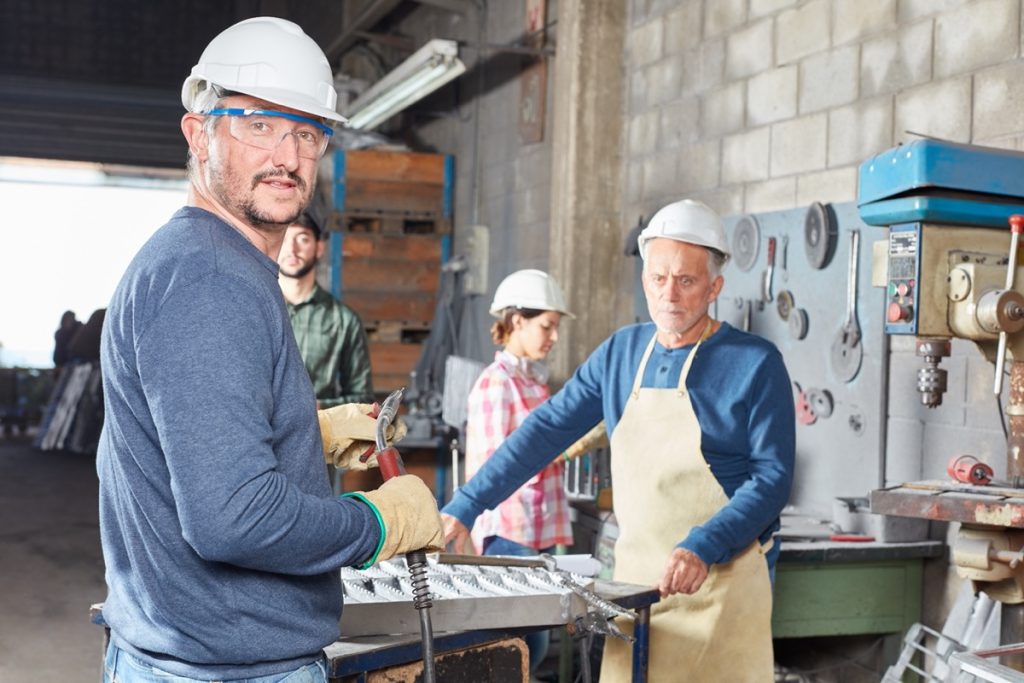 Workers in shop; union dues myths concept