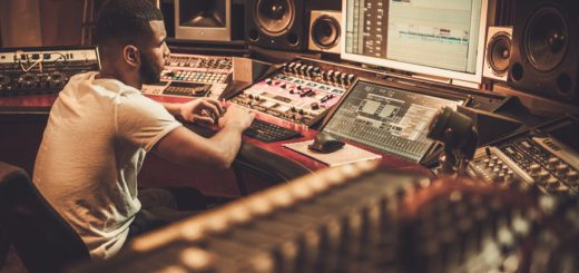 Sound engineer working at mixing panel in boutique recording studio; successful union drives concept