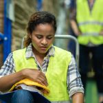 Downcast worker sitting in warehouse; Anti-Labor State Laws concept