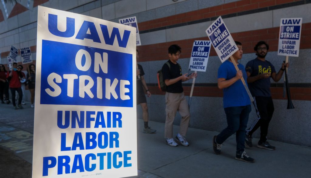 UAW members on strike and picketing; EV transition concept