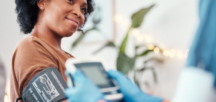 Person having blood pressure taken; healthcare benefits concept